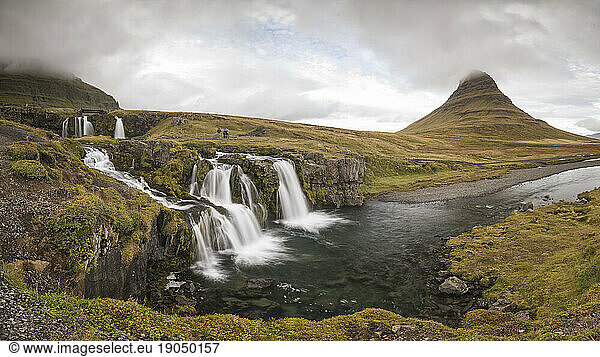 Kirkufell mountain in panoramic view with small waterfalls
