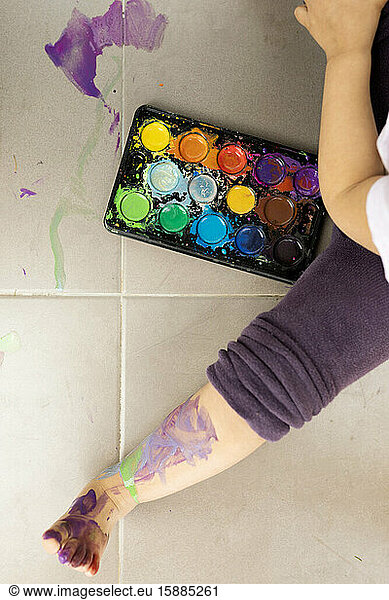 Kleines Mädchen malt mit Aquarellfarben