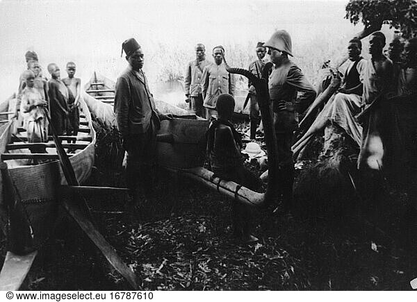 Koch  Robert German physician anad bacteriologist.
1843 – 1910. Robert Koch (with sun helmet) as participant of the German expedition in search of the pathogen causing sleeping sickness (trypanosomiasis) on boats in East Africa. Photo  1905–06.