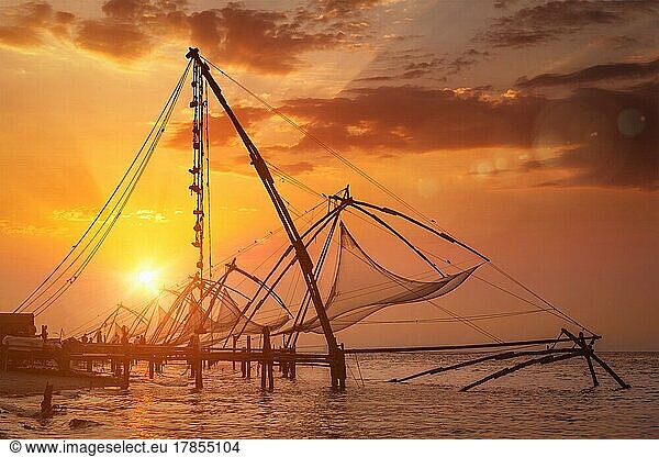 Kochi chinese fishnets on sunset. Fort Kochin  Kochi  Kerala  India. With lens flare and light leak