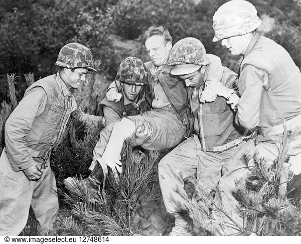 KOREAN WAR (1950-1953). A Marine wounded by a sniper's bullet near ...