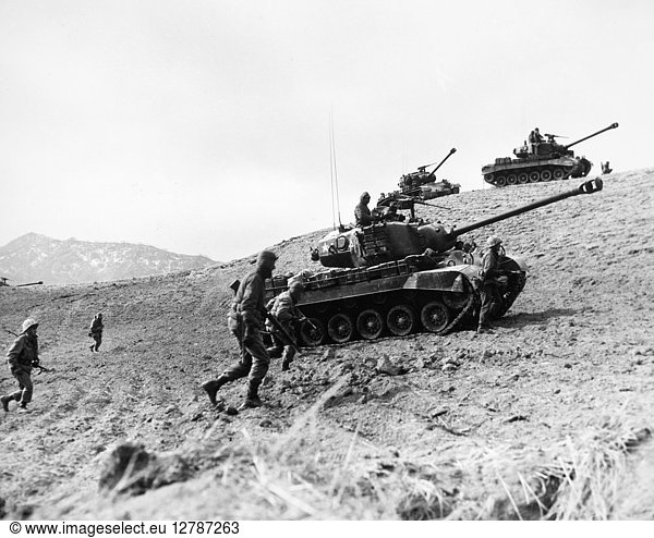 KOREAN WAR: INFANTRYMEN. American Infantrymen supported by tanks advance up a hill in Korea, 1952.