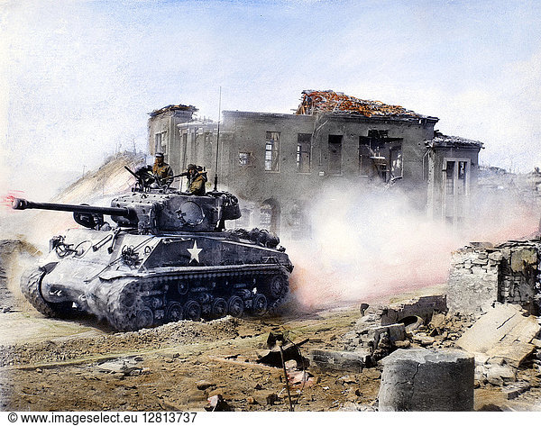 KOREAN WAR: TANK,  1951. An American First Division tank drives north through Chunchon,  on the central front in Korea,  March 1951. Oil over a photograph.