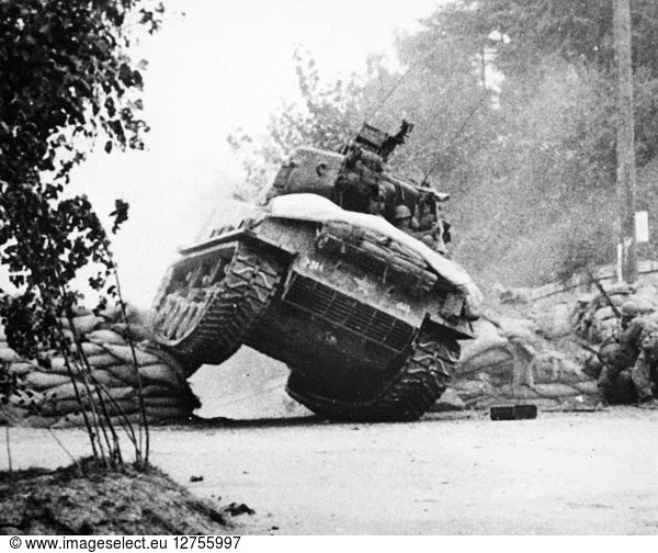 KOREAN WAR: TANK,  1950. An American tank crashes through an enemy roadblock near Seoul,  South Korea,  October 1950.