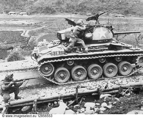 KOREAN WAR 1951. A U.S. Infantry division fires at a group of Chinese Communists while on patrol somewhere in Korea June 1951.