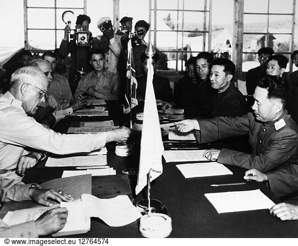 KOREAN WAR: ARMISTICE. U.S. General Blackshear M. Bryan (left) exchanging credentials with Major-General Lee Sang Cho of North Korea at the opening session of the United Nations Command Military Armistice Commission (UNCMAC)  in the conference house at Panmunjom  Korea  28 July 1953  one day after the signing of the armistice that ended the Korean War.
