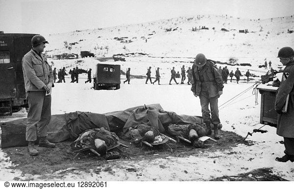 KOREAN WAR: DEAD  1951. U.S. Army medical corpsmen identifying dead soldiers on the west-central front  Korea. Photographed 1951.