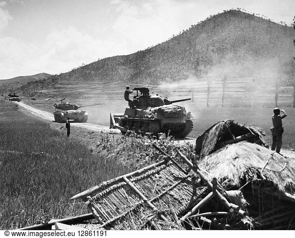 KOREAN WAR: FRONT  1950. U.S. Marine tanks fire at enemy positions in the ridges of the Korean front near the Naktong River  August 1950.