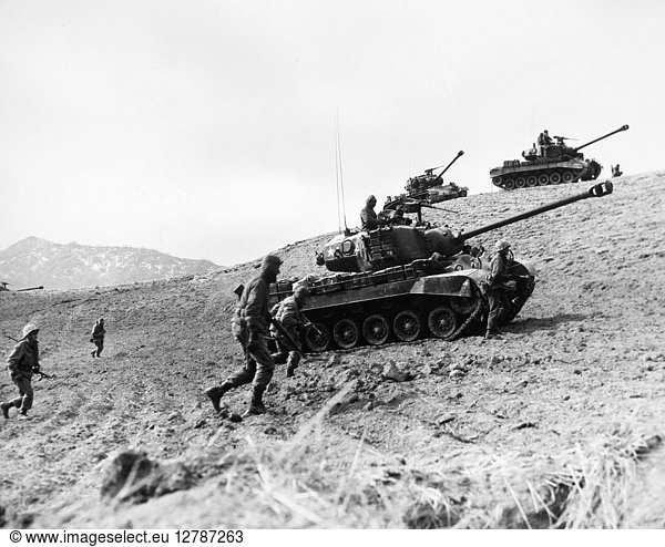 KOREAN WAR: INFANTRYMEN. American Infantrymen supported by tanks advance up a hill in Korea  1952.