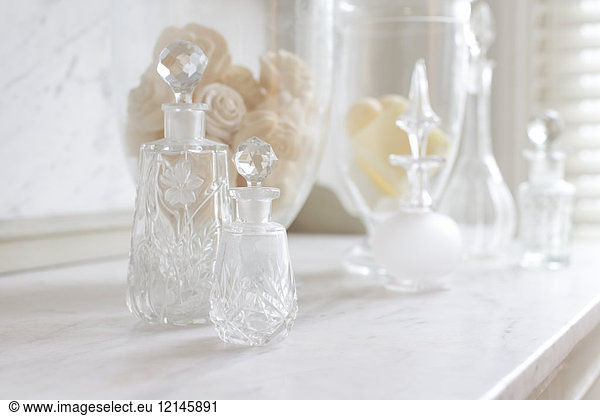 Kristall-Parfümflaschen auf weißer  luxuriöser Marmortheke