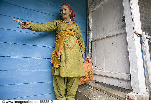 Kullu woman in front of her colorful house in Manali