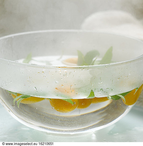 Kumquats in bowl with hot water