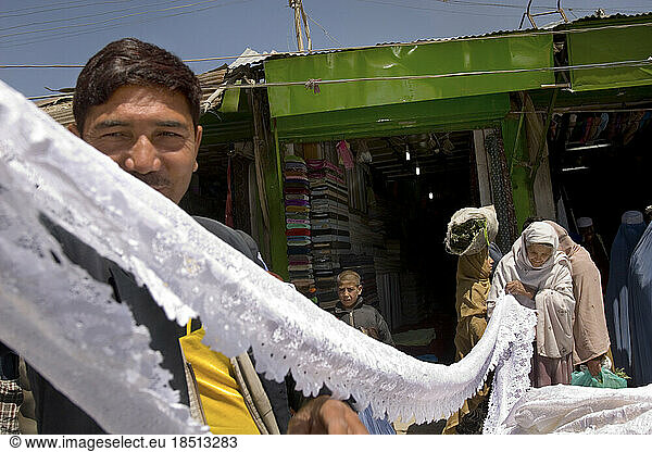 Lace and cloth vendor at a central market in Kabul.