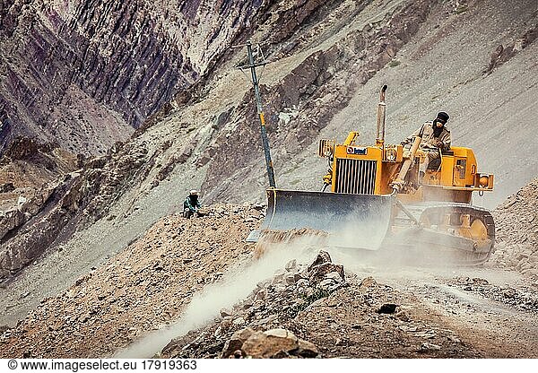 LADAKH  INDIA  SEPTEMBER 10  2011: Bulldozer cleaning road after landslide in Himalayas. Ladakh  Jammu and Kashmir  India  Asia