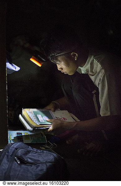 Lagaï  13  preparing his satchel with a flashlight  Pulau Siberut  Sumatra  Indonesia