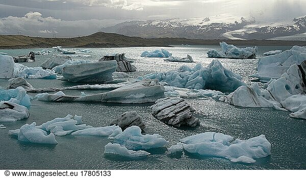 Lake Jökulsárlón with turquoise ice chunks and mountains in the background  Iceland  Europe