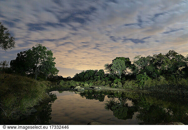 Landscape of a waterhole at dusk  reflection in water