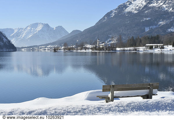 Landscape of Bench Full of Snow next to Lake Grundlsee in Winter  Styria  Austria