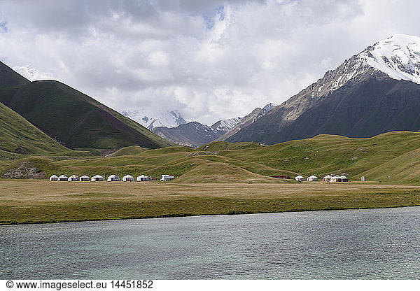 Landscape view with lake and snow capped mountains  Tulpar Kul  Kyrgyzstan.