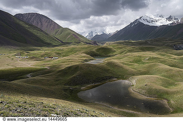 Landscape view with lakes in a valley surrounded by snow capped mountains  Tulpar Kul  Kyrgyzstan.