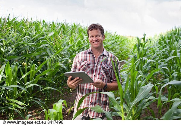 Landwirt im Ackerbau mit digitaler Tablette