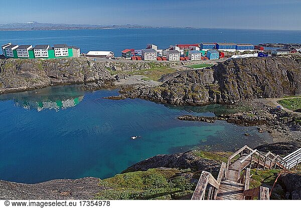Lange Holz-Treppe führt hinunter zu einer Bucht  Sommer  moderne Wohnhäuser im Mittelgrund  Maniitsoq  Grönland  Dänemark  Nordamerika