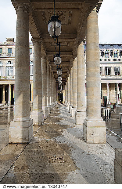 Lanterns amidst architectural columns in historical building
