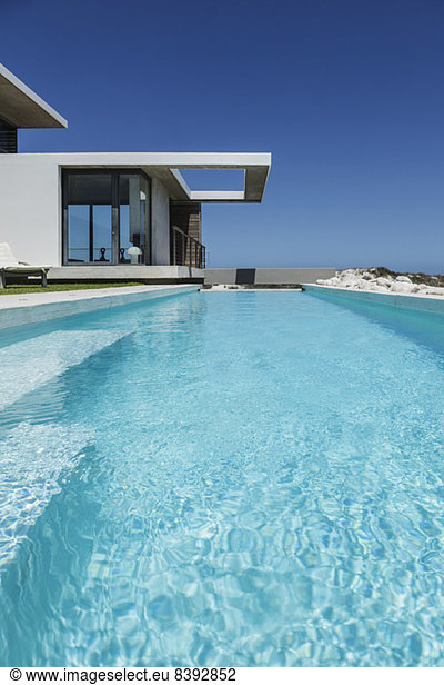 Lap pool outside modern house