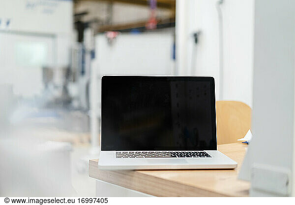 Laptop on desk at industry