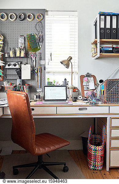 Laptop on desk in creative home office