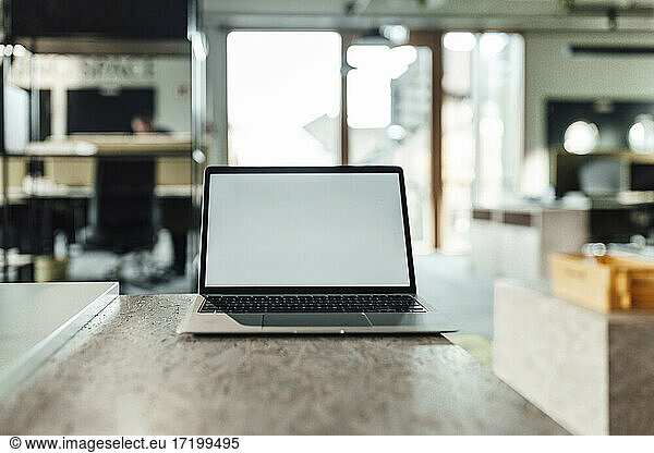 Laptop on desk in office