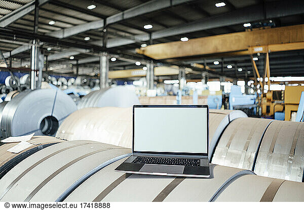 Laptop on manufactured metal sheet in industry