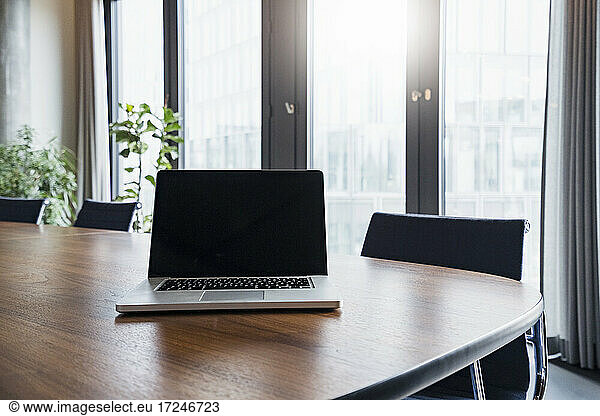 Laptop on table in board room at modern work place