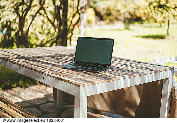 Laptop on table in garden