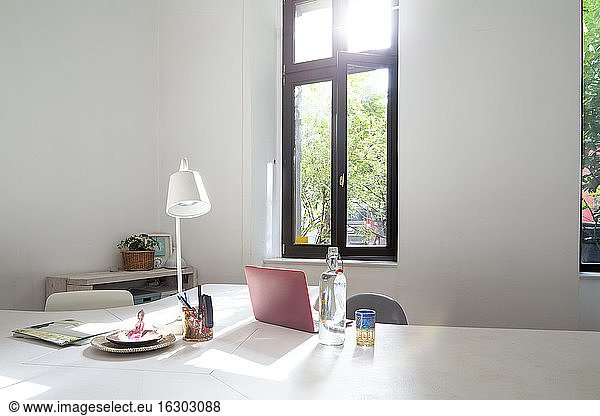 Laptop on table in modern home office