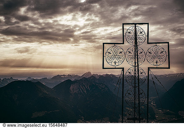 Large cross structure on peak  mountain ranges in background  Bludenz  Vorarlberg  Austria