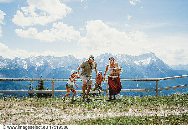 Large family having fun in summer in mountains Alps