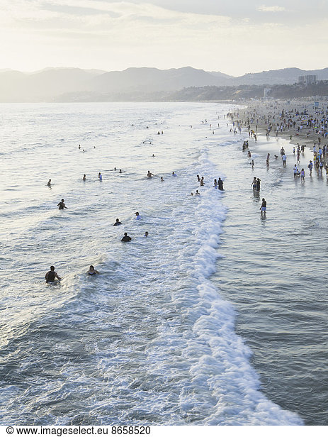 Large group of people swimming in the ocean at Santa Monica  California.