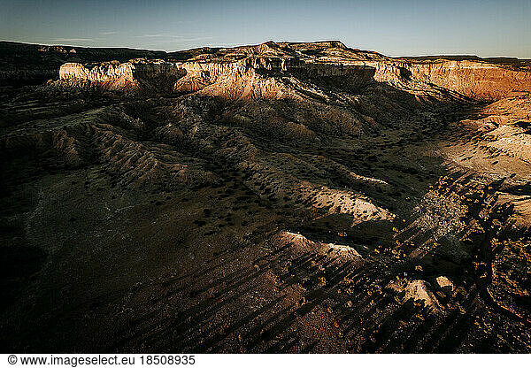 Late day sun hitting desert cliffs of Ghost Ranch  New Mexico