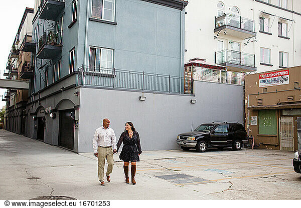 Late Forties Couple Holding Hands Walking in Alley in San Diego