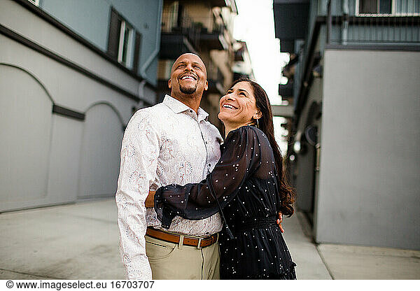 Late Forties Couple Laughing Standing in Alley in San Diego