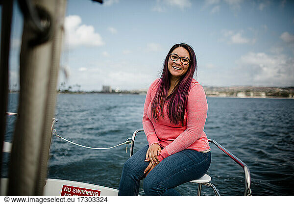 Late Thirties Hispanic Woman Sitting on Boat in Bay in San Diego