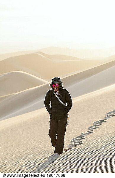 laughing female wanderer walking in the desert of colorado