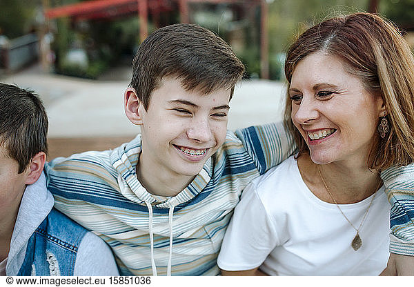 Laughing mom and teen son sharing a happy moment