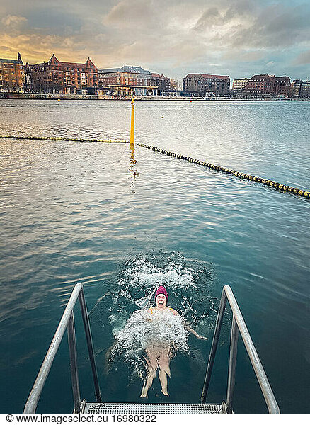 Laughing Winter Bather Making Waves In Still Water Copenhagen  Denmark
