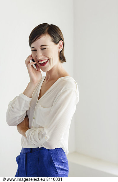 Laughing woman talking on cell phone