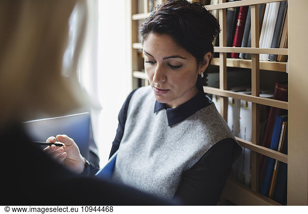 Lawyer discussion with female lawyer in library