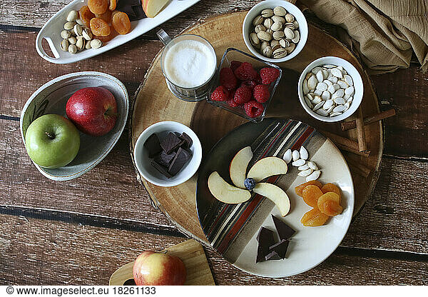 layflat shot of fruit and nut charcuterie board brown background