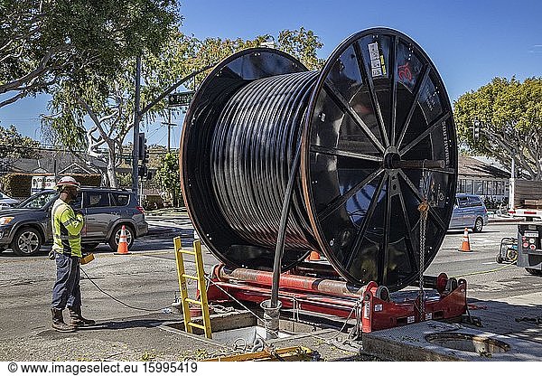 Laying down underground cable  Culver City  Los Angeles  California  USA.