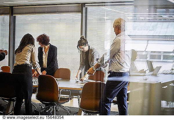 Legal professionals working at conference table in board room
